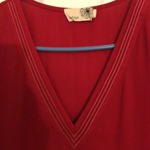 Sleeveless large red Everleigh v-neck blouse with white contrast stitch at neck